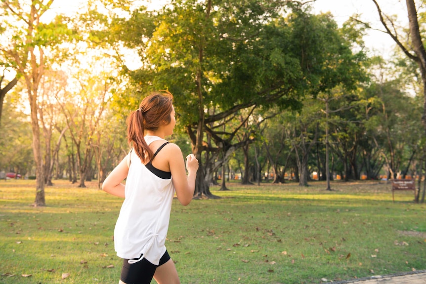 A woman runs in a park