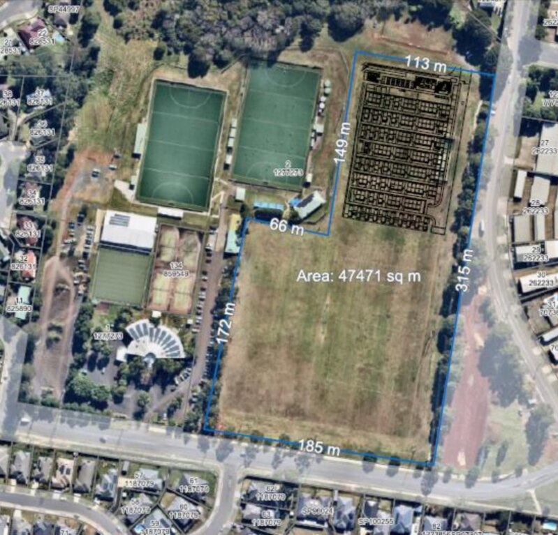 Aerial photo of park with sports fields, with one section covered by black diagram.