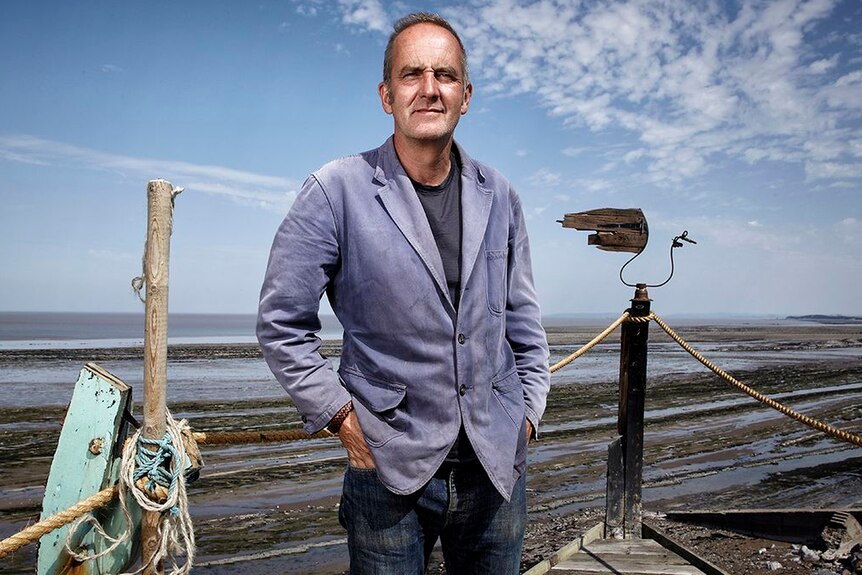 Grand Designs host Kevin McCloud on the beach.