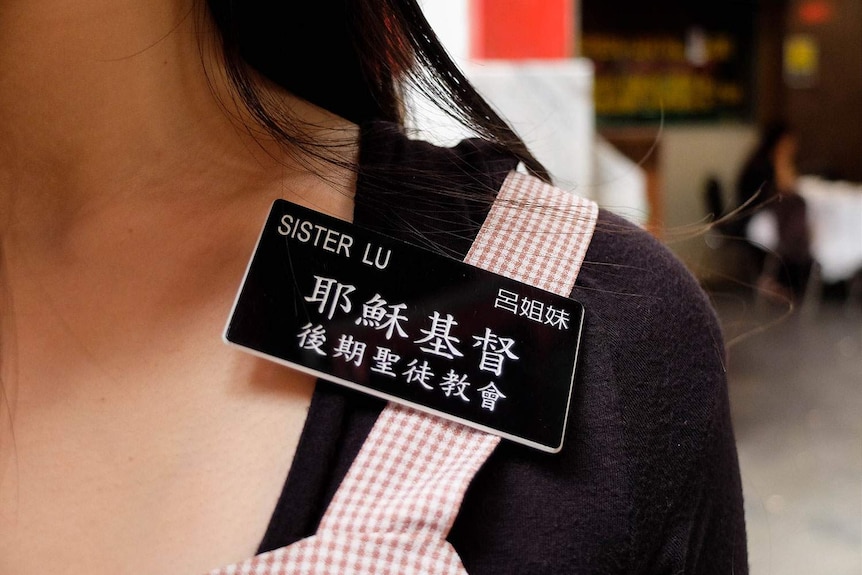 Missionary Sister Lu's name tag written in English and Chinese.
