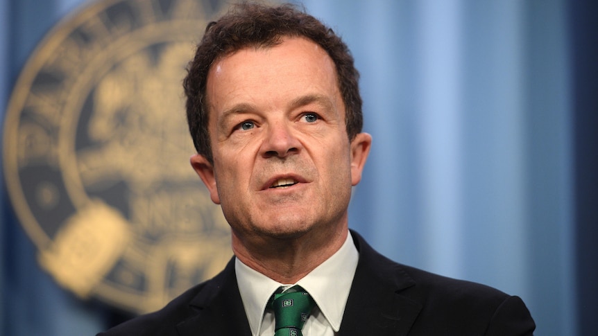 a man speaking behind a lectern