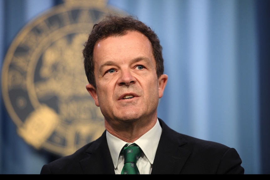 a man speaking behind a lectern