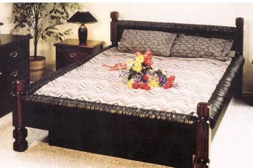 A classic-style, black, vinyl waterbed.