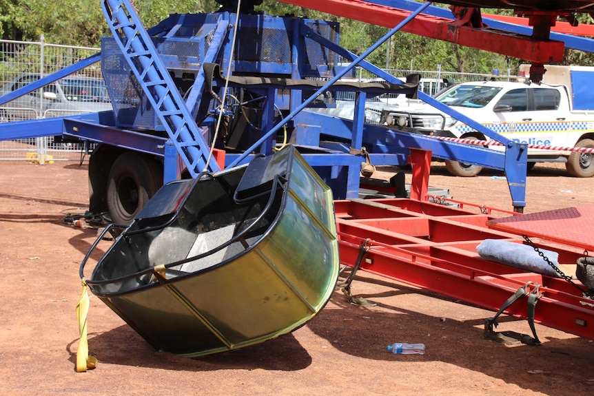 A ride carriage sits on the ground.