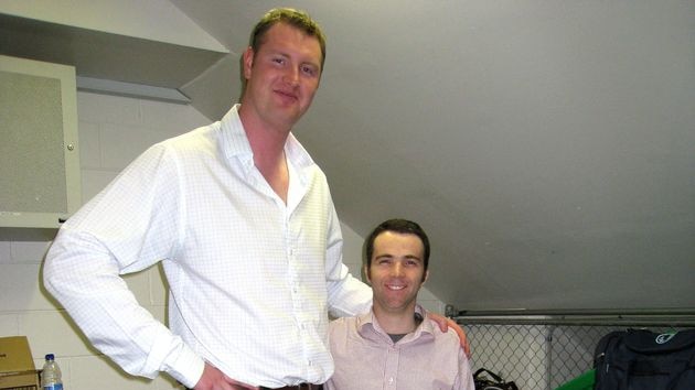 At 233 centimetres tall, Fingleton (pictured with a reporter) is the tallest man in the English-speaking world.