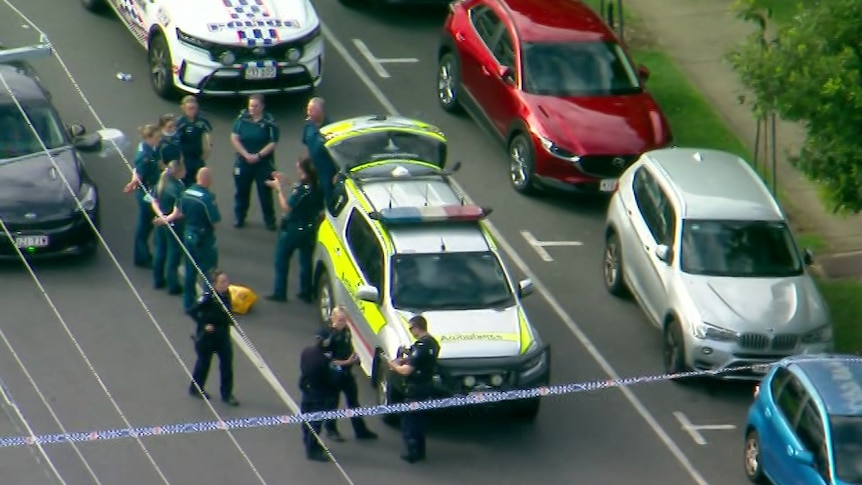 Aerial of police and ambulance officers at the scene of South Brisbane shooting