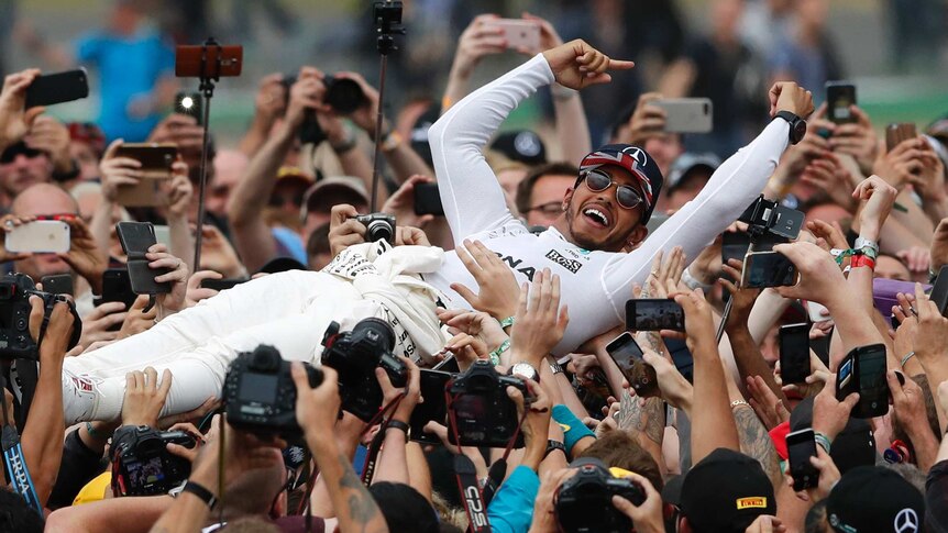 Mercedes driver Lewis Hamilton of Britain celebrates after winning the British Formula One GP.