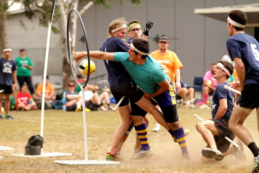 men and women battle it out on the quidditch field during a state of origin match