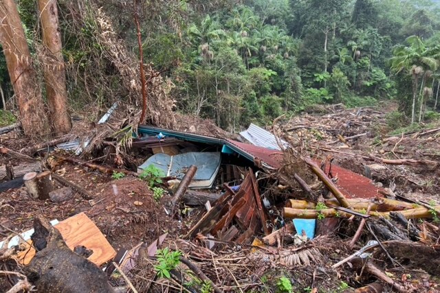 Rubble of a house covered in landslide debris.
