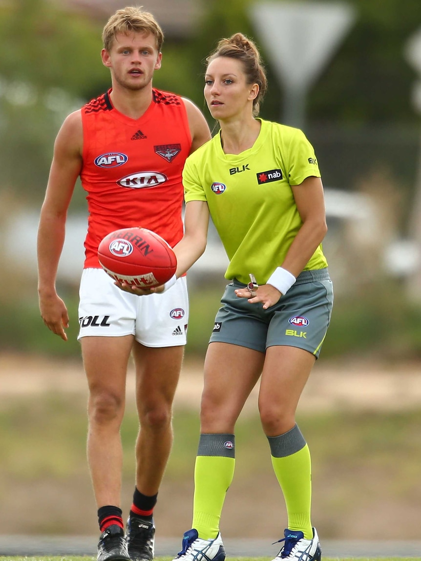 Umpire Eleni Glouftsis throws the ball in during play in an Essendon intra-club match.