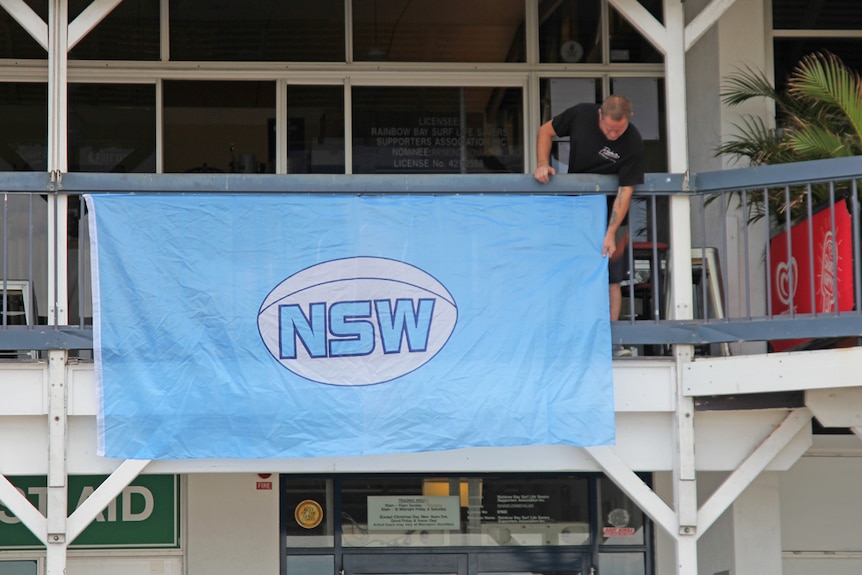 A New South Wales flag is hung on Rainbow Bay Surf Life Saving Club