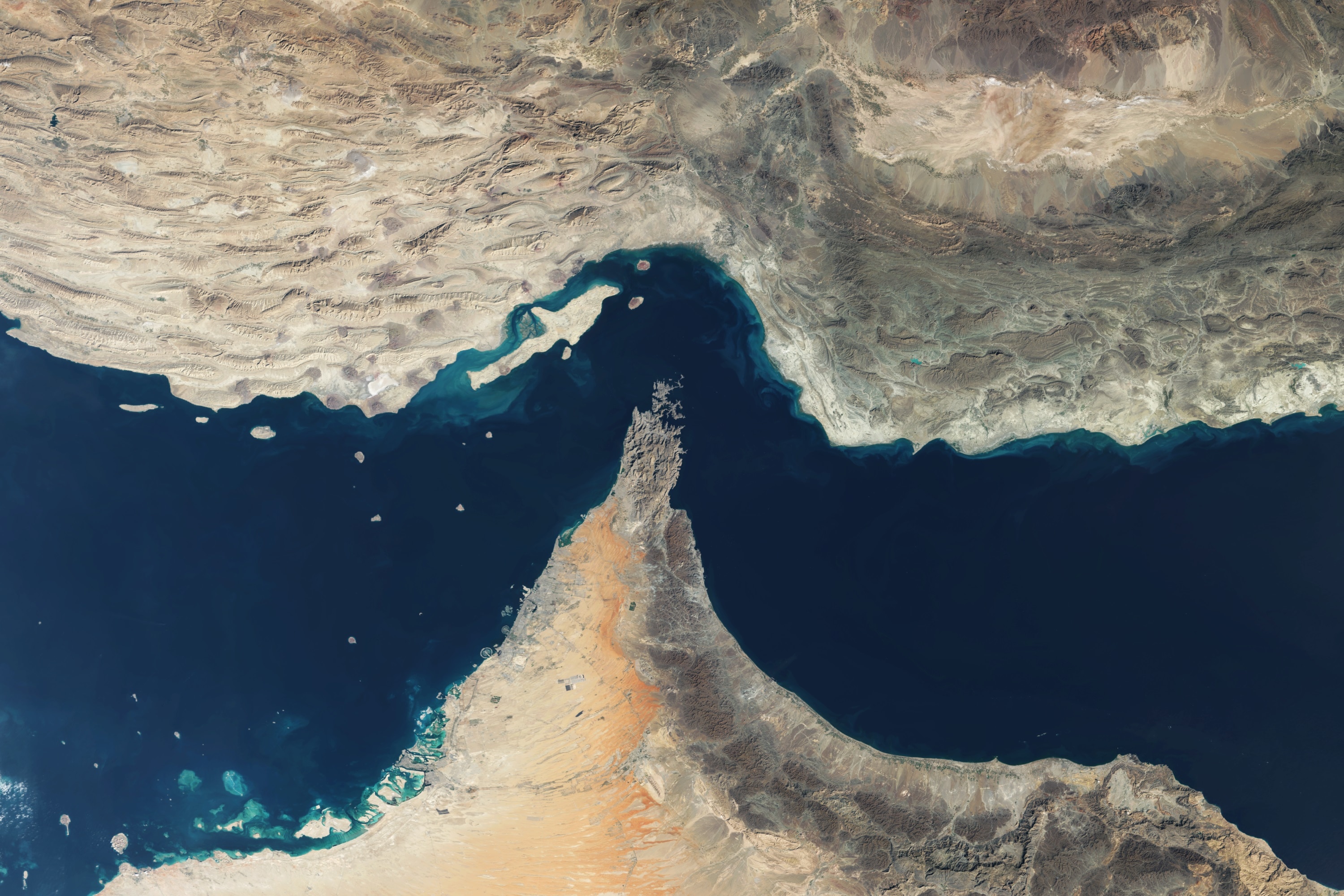 A satellite image showing a body of water surrounded by two lands.