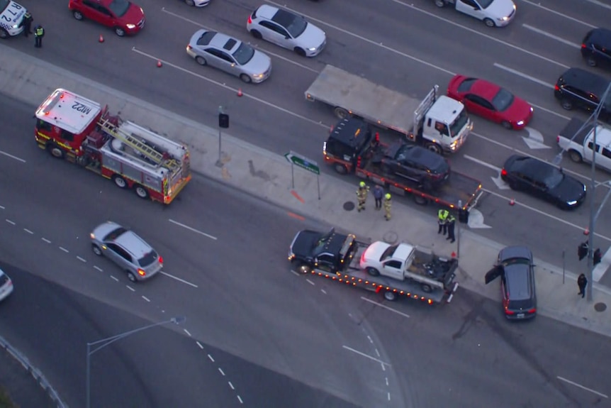Cars and tow trucks from aerial view.