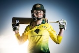 Amanda-Jade Wellington poses with cricket bat in Australian uniform
