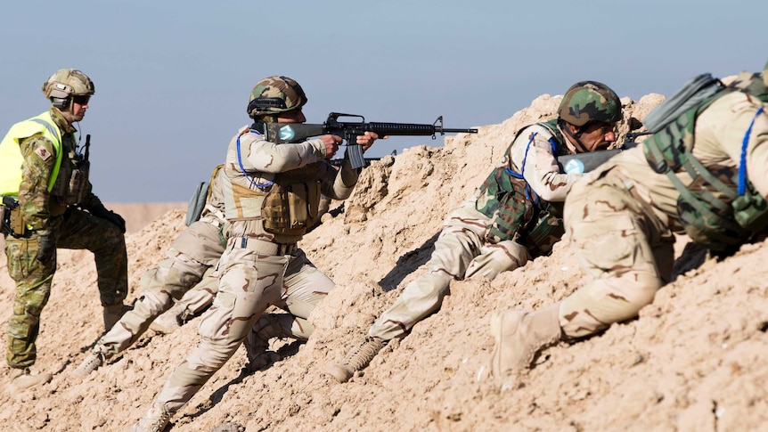 An Australian soldier trains Iraqi soldiers
