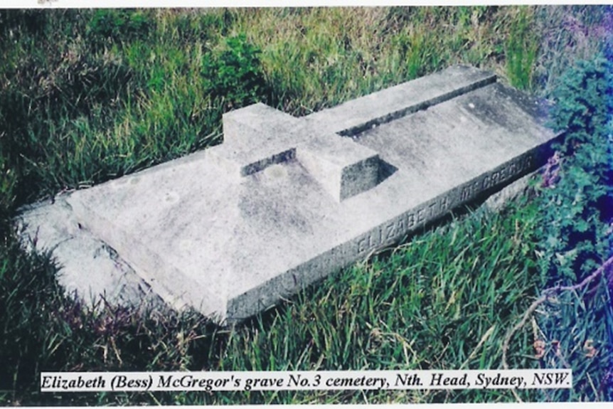 A stone grave with a person-sized cross on top.