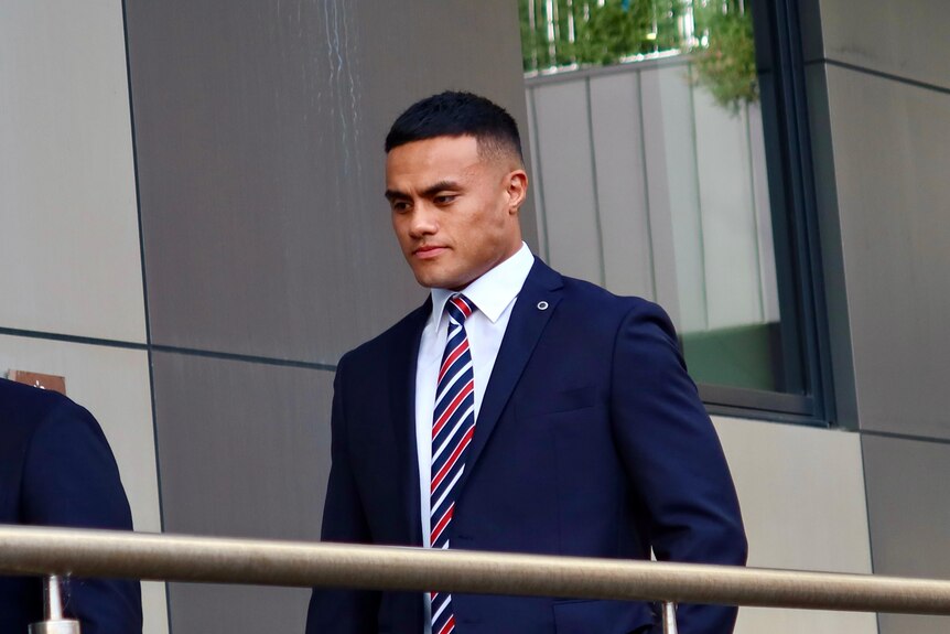 Sydney Roosters prop Spencer Leniu wears a suit as he walks into his NRL judiciary hearing.
