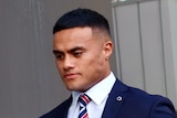 Sydney Roosters prop Spencer Leniu wears a suit as he walks into his NRL judiciary hearing.