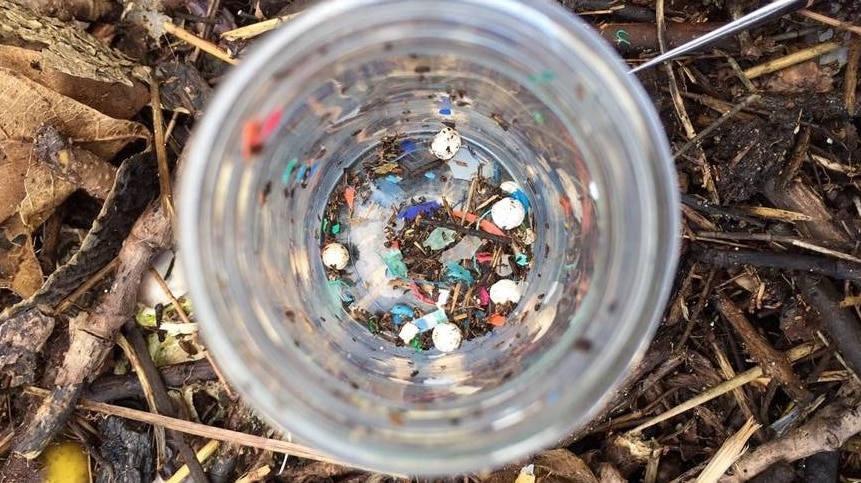 A glass filled with tiny flecks of coloured plastic