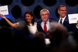 The mayors of Paris and Los Angeles hold up signs confirming their winning Olympic bids.