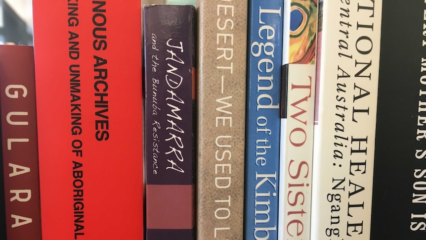 A close up of a set of books showing their spine titles