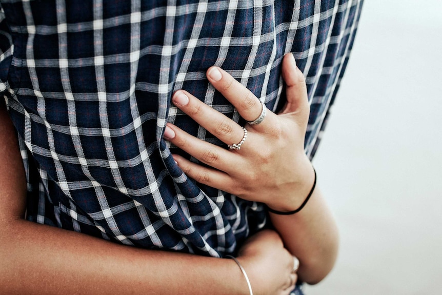 Close up of two people hugging illustrating the support that loved ones can offer people with serious health diagnoses.