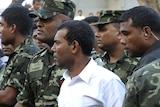 Former Maldivian president Mohamed Nasheed (wearing white) says he was forced from power at gunpoint.