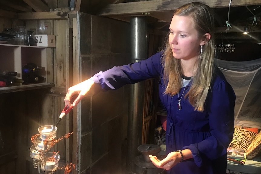 Victoria O'Sullivan lighting candles.