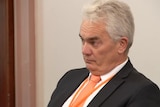 John Lenders listening to someone speak at a Victorian parliamentary inquiry hearing.