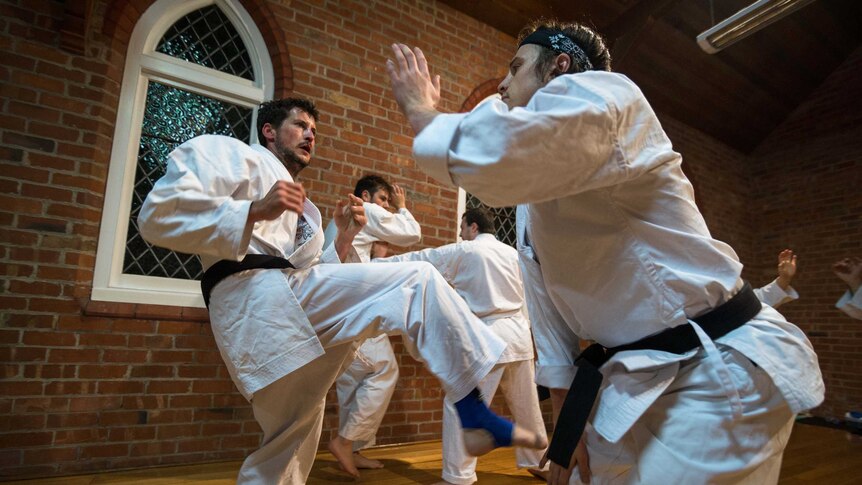 Goju-Ryu karate black belts spar in their Sandford dojo