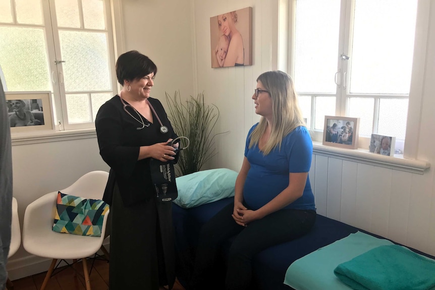 Liz Wilkes with a patient at her midwifery practice.