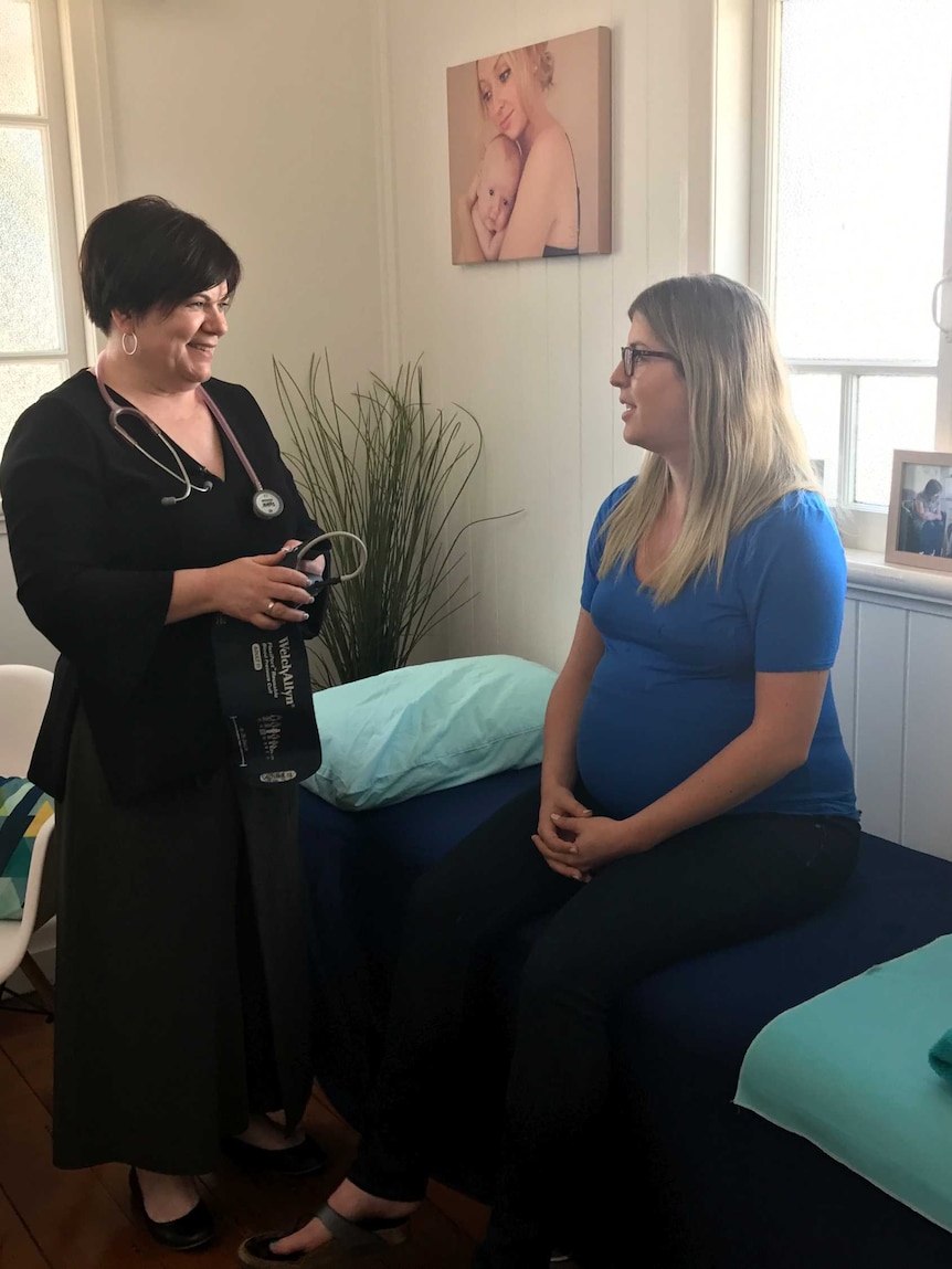 Liz Wilkes with a patient at her midwifery practice.