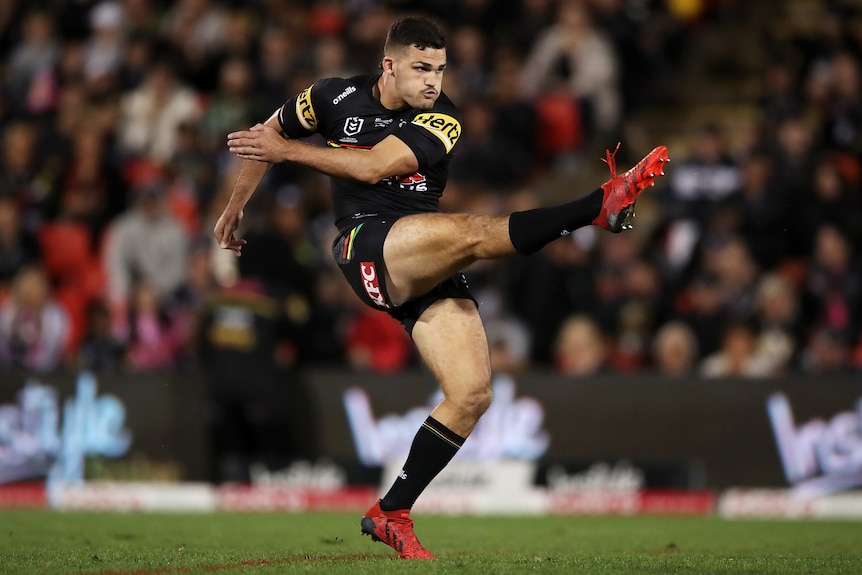 Penrith Panthers' Nathan Cleary finished a kicking motion during an NRL game.