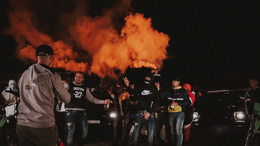 A group of men with flares.