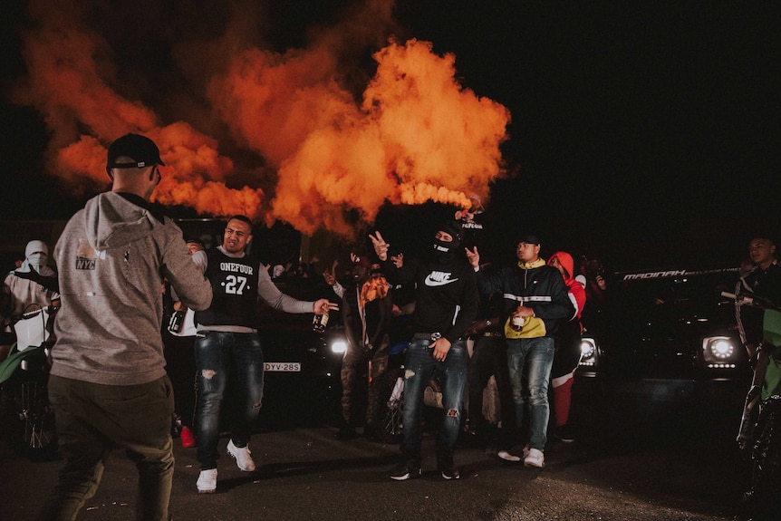 A group of men with flares.