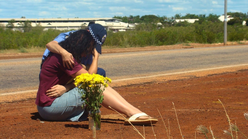 Ingrid Bishop is consoled after remembering her son