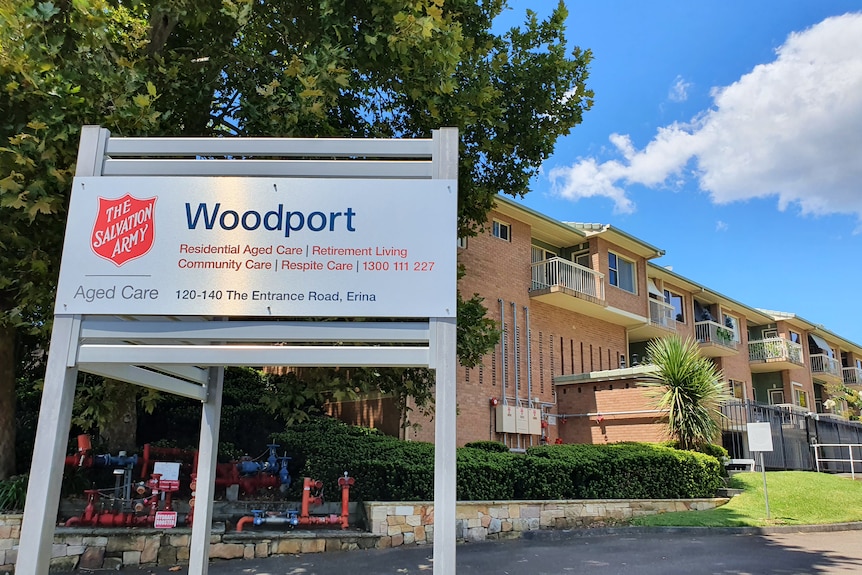 A large residential brick building, with a sign at the front saying "Woodport" and a Salvation Army logo.