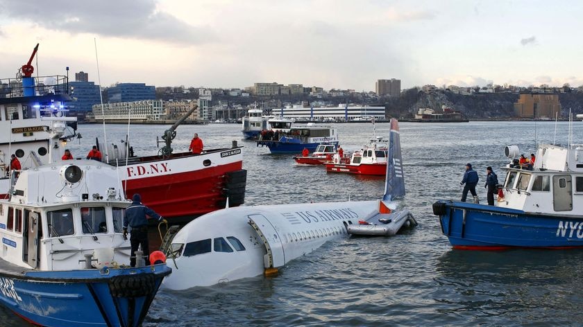 Emergency personnel search for passengers after a US Airways plane ditched in the Hudson River