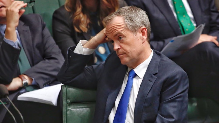 Bill Shorten leans on his arm during Question Time.