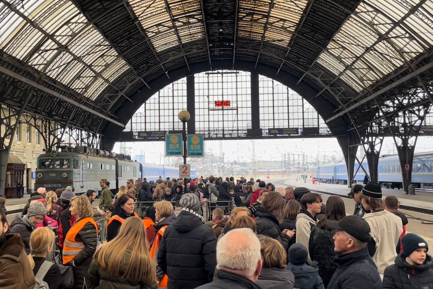 A crowd on a train station platform