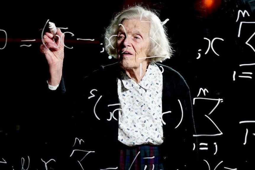 Alison Harcourt works on a maths equation on a glassboard