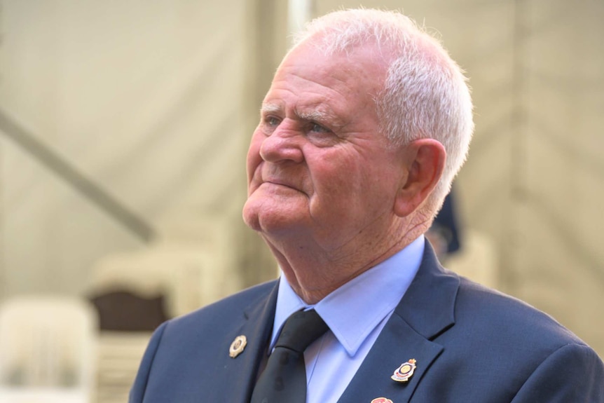 A man with service medals displayed on his chest