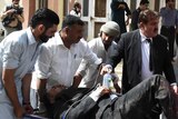 Pakistani lawyers use a stretcher to move an injured colleague after a bomb explosion at Quetta hospital