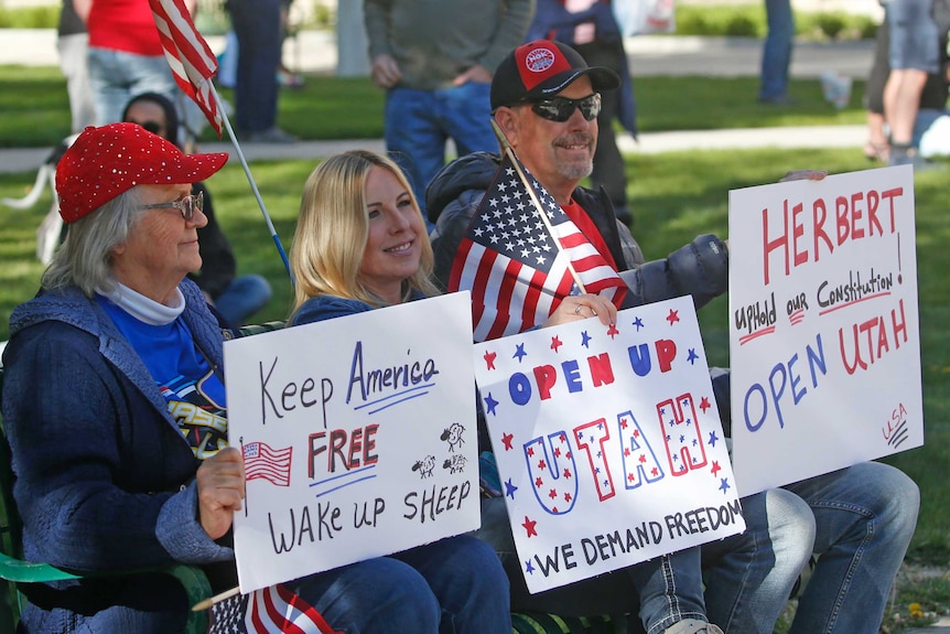 People gather for a protest calling for the US state of Utah's economy to be reopened.