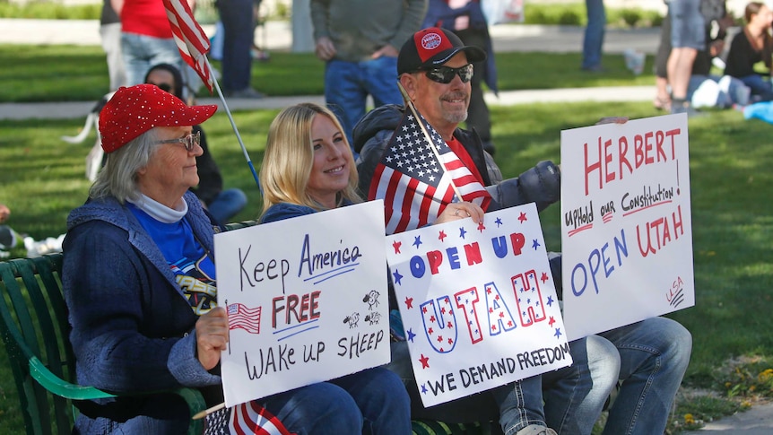 People gather for a protest calling for the US state of Utah's economy to be reopened.