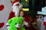 a child sitting on santa's lap