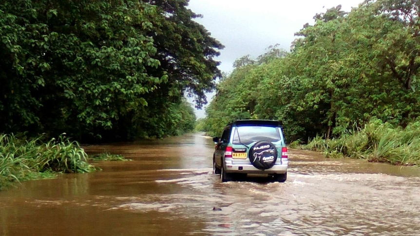 Car drives through floodwater in Solomon Islands