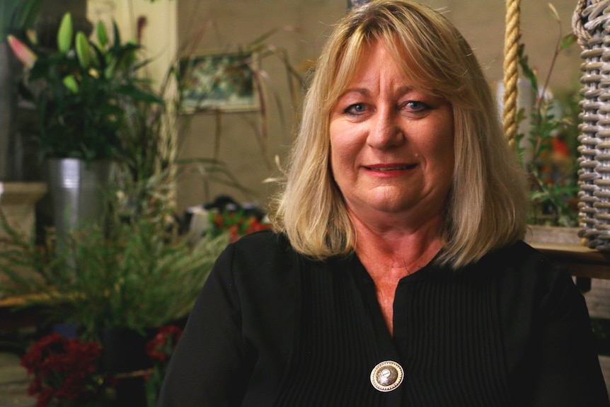 A portrait of a woman wearing a black shirt.