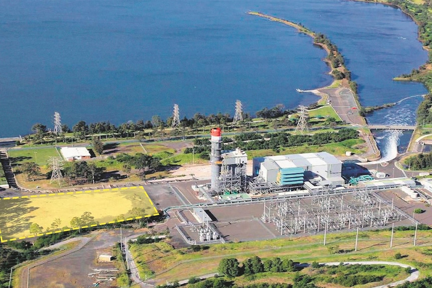 Aerial view of industrial site sitting next to blue lake