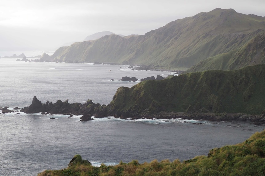 a lookout over an island with low cloud